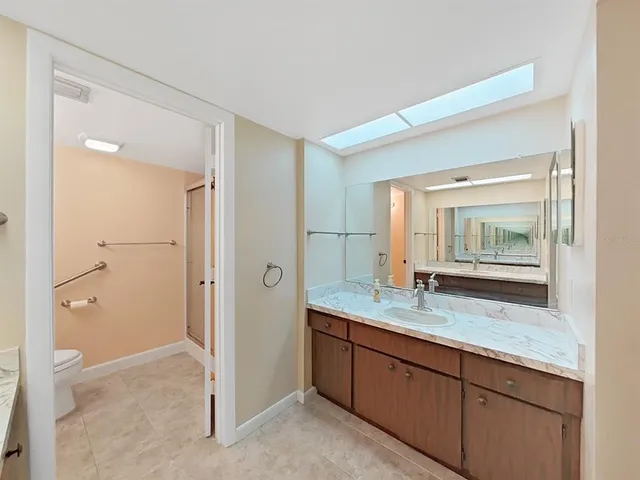 a bathroom with a granite countertop sink mirror and double