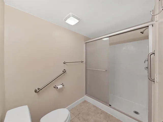 a bathroom with a shower and toilet