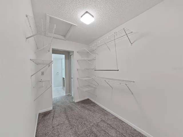 a view of walk in closet with white walls