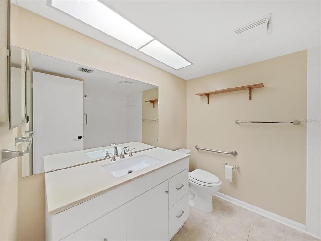 700 Starkey Road, Unit 644 Largo, FL 33771 - Photo 19 of 30 a bathroom with a sink a toilet and shower