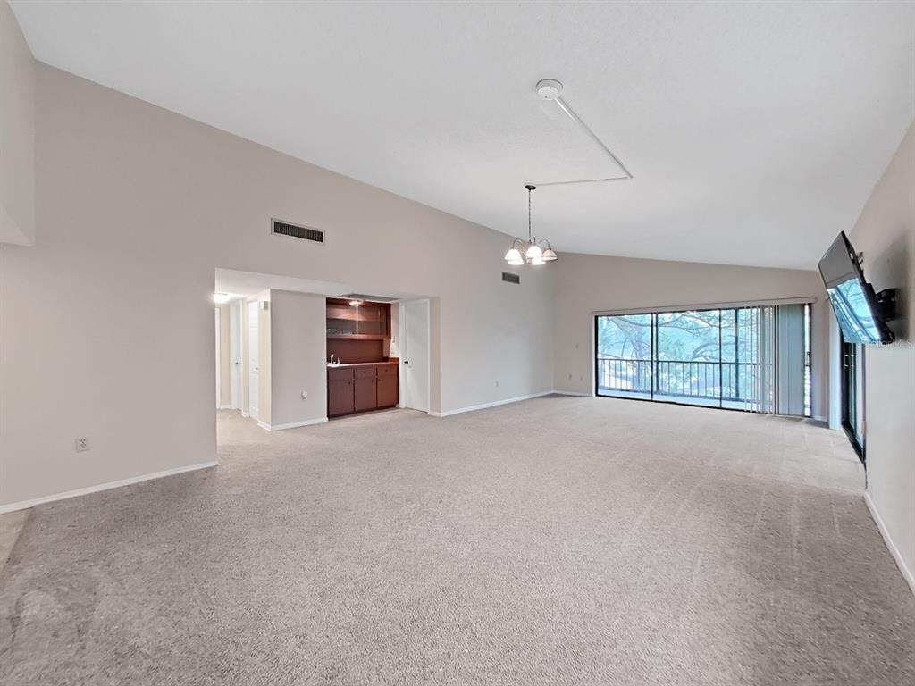 700 Starkey Road, Unit 644 Largo, FL 33771 - Photo 3 of 30 a view of an empty room with a window and a kitchen