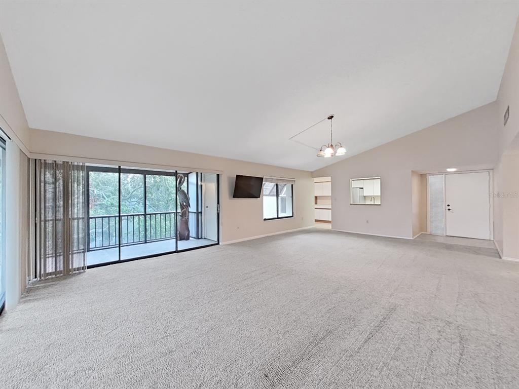 700 Starkey Road, Unit 644 Largo, FL 33771 - Photo 4 of 30 a view of a big room with windows and chandelier fan