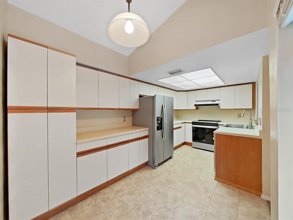 700 Starkey Road, Unit 644 Largo, FL 33771 - Photo 7 of 30 a kitchen with a refrigerator and a stove