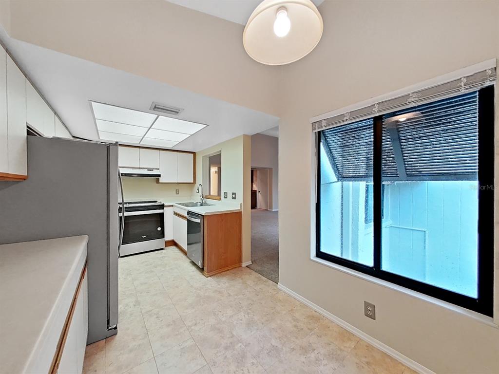 700 Starkey Road, Unit 644 Largo, FL 33771 - Photo 8 of 30 a kitchen with cabinets and window