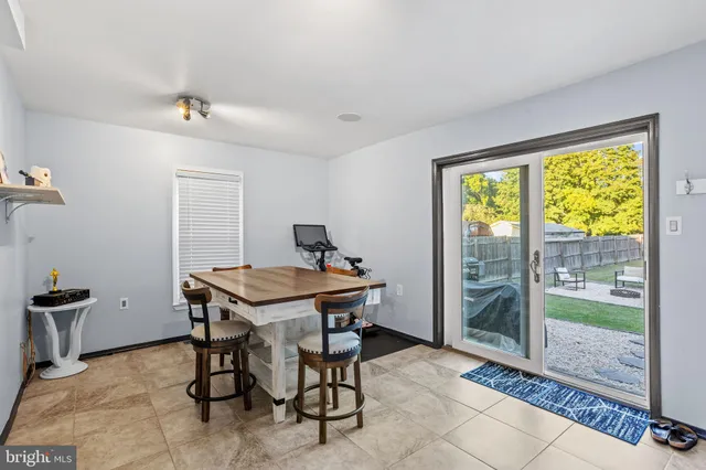 a view of a room with a table and chairs