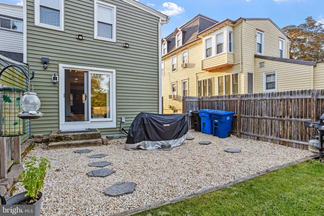 a backyard of a house with fire pit and outdoor seating