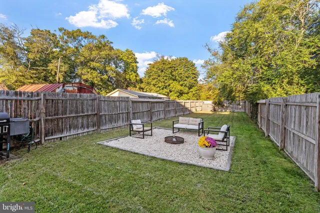 a view of a garden with a house in the background