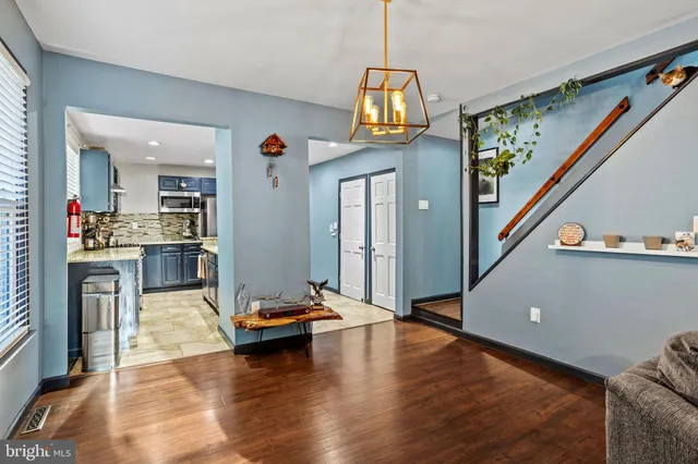 a living room with furniture and a chandelier