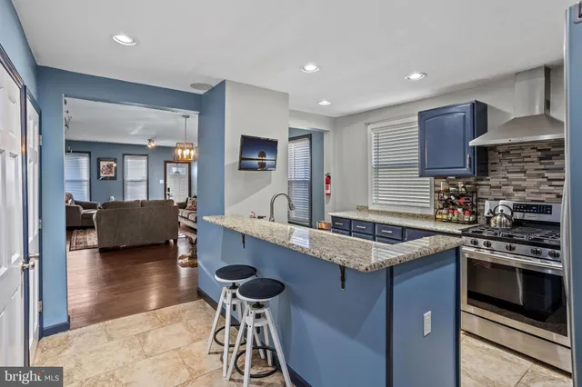 a kitchen with a sink a counter top space and stainless steel appliances