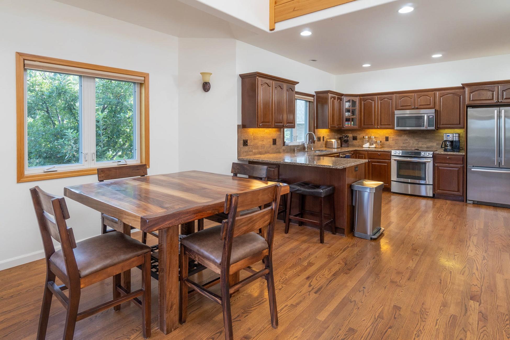 61899 Dobbin Court Bend, OR 97702 - Photo 8 of 26 a view of a dining room with furniture window and wooden floor