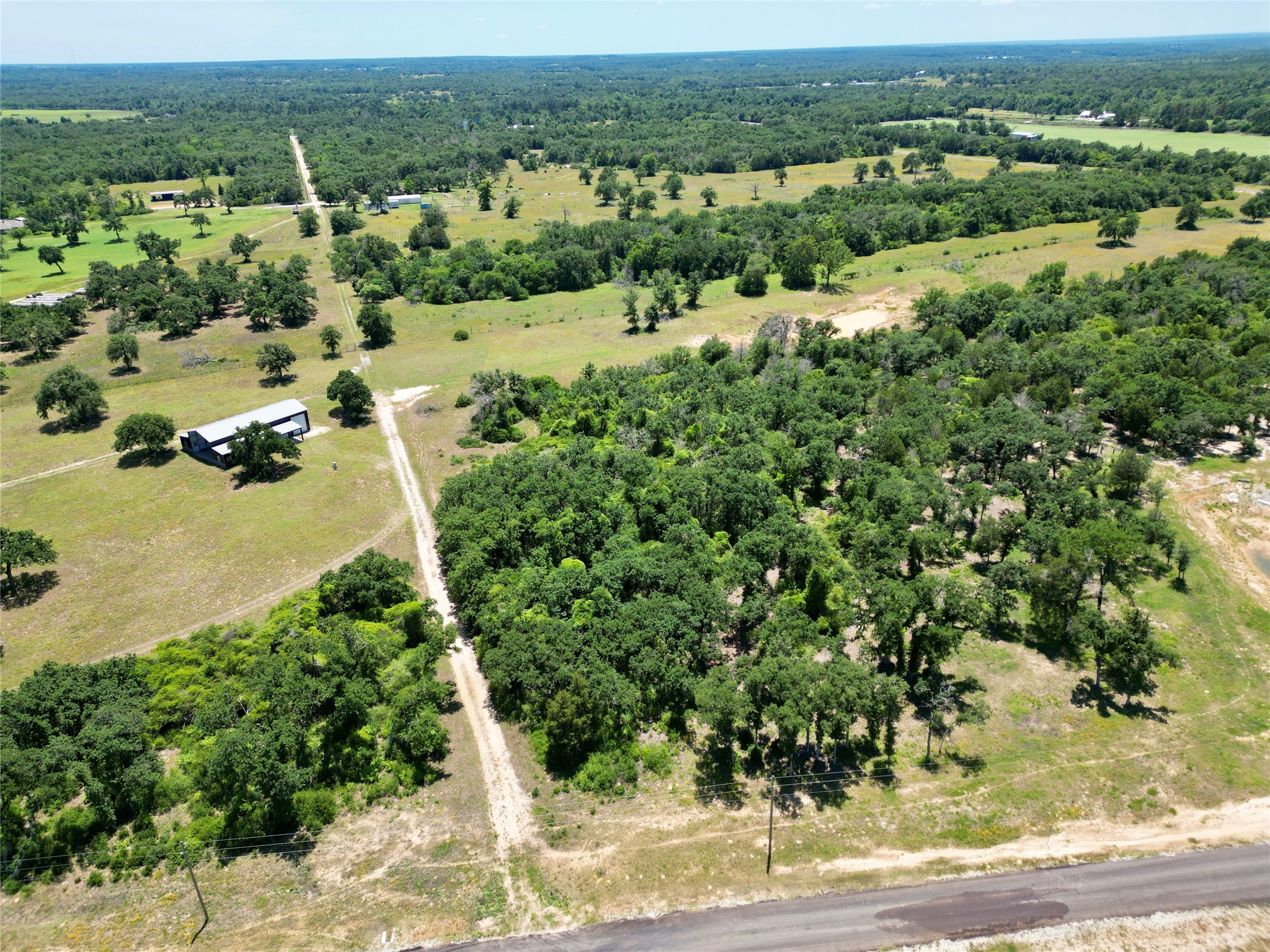 3803 Private 4100 Road Marquez, TX 77865 - Photo 2 of 11 an aerial view of a houses with a yard and lake view
