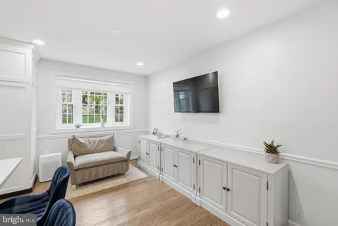 a spacious bedroom with a bed a couch and a flat screen tv