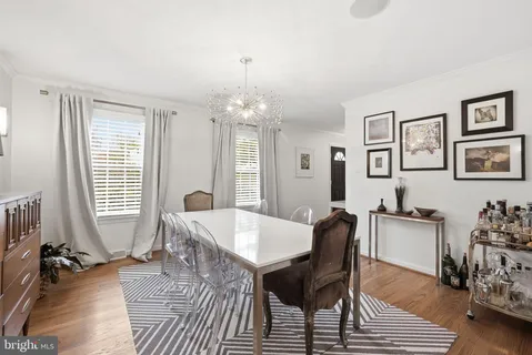 a view of a dining room with furniture and chandelier
