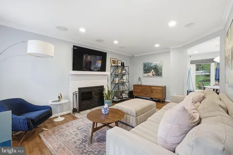 a living room with furniture a fireplace and flat screen tv