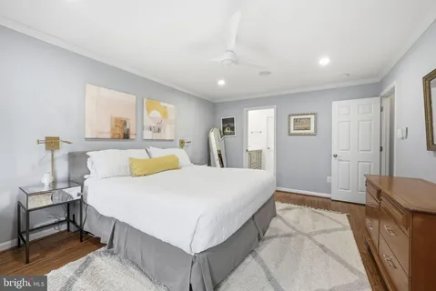 a bedroom with a large bed and a dresser