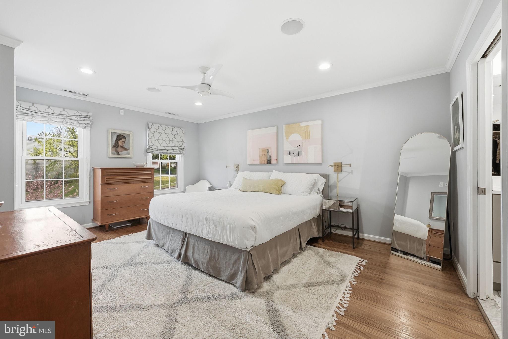 9503 Rockport Road Vienna, VA 22180 - Photo 25 of 48 a spacious bedroom with a bed a table and potted plant with the dresser