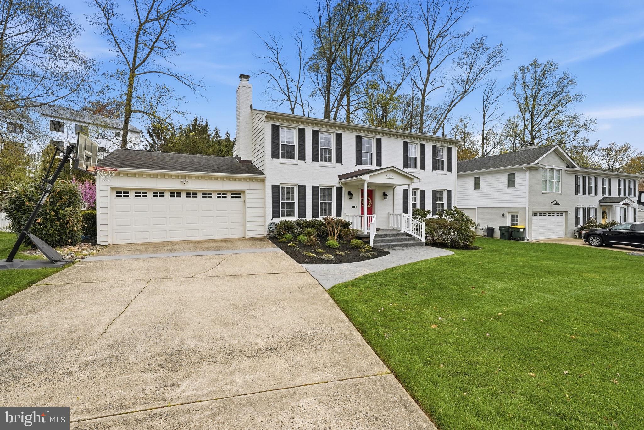 9503 Rockport Road Vienna, VA 22180 - Photo 3 of 48 a front view of a house with a garden and trees