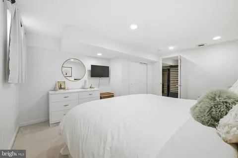 a bedroom with a bed and a couch