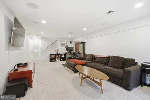 a view of a patio with table and chairs and couches with wooden fence and floor
