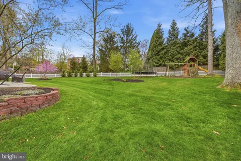 a view of a house with backyard sitting area and garden