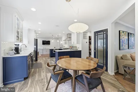 a view of a dining room with furniture and a chandelier