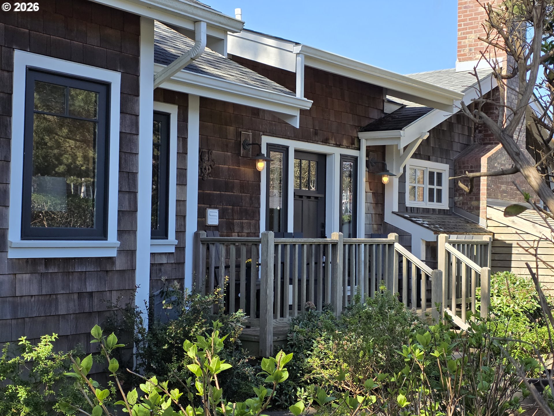 front view of a house with a flower garden