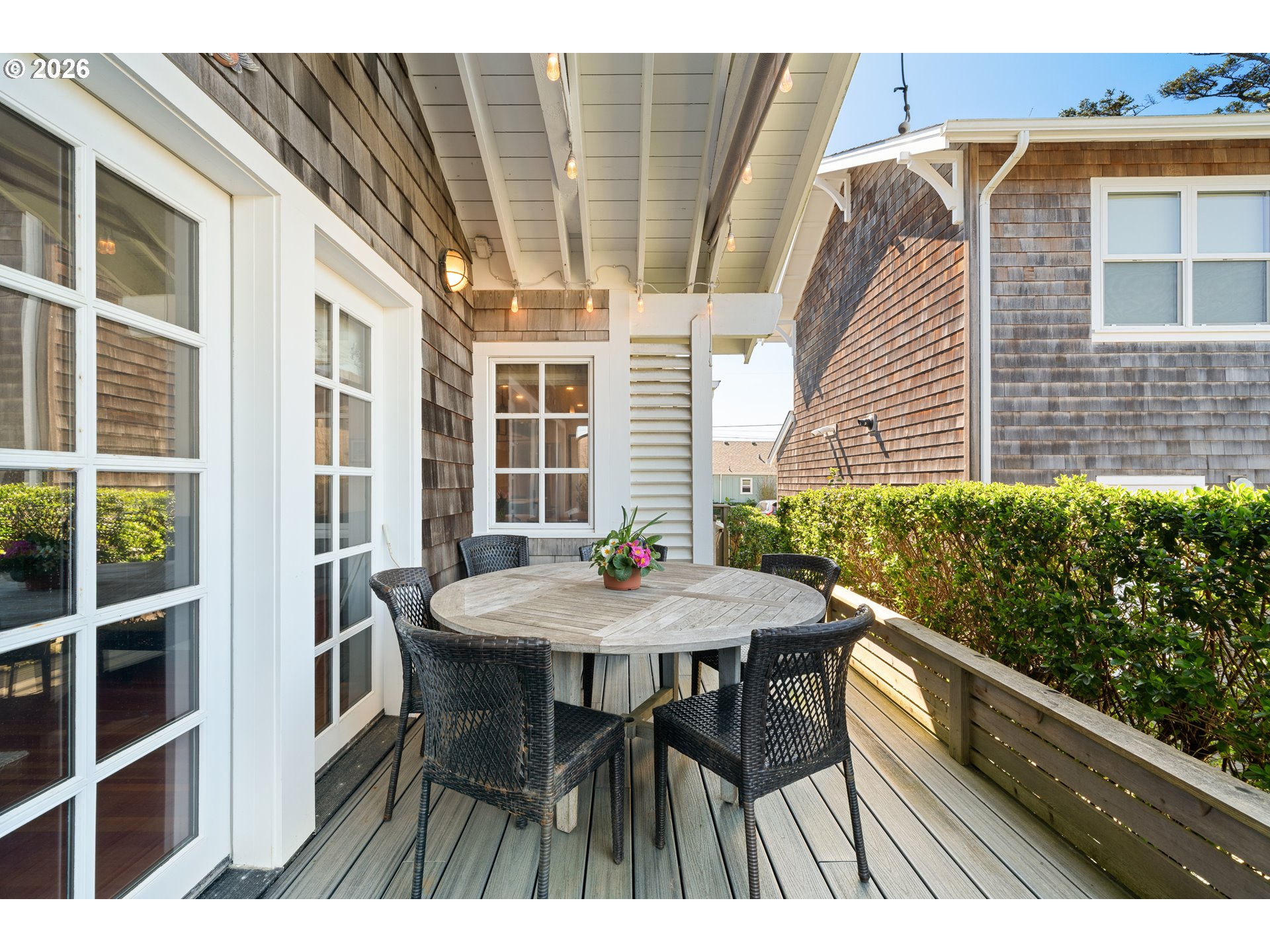 108 West Madison Street Cannon Beach, OR 97110 - Photo 18 of 45 a view of a patio with table and chairs with wooden floor and fence