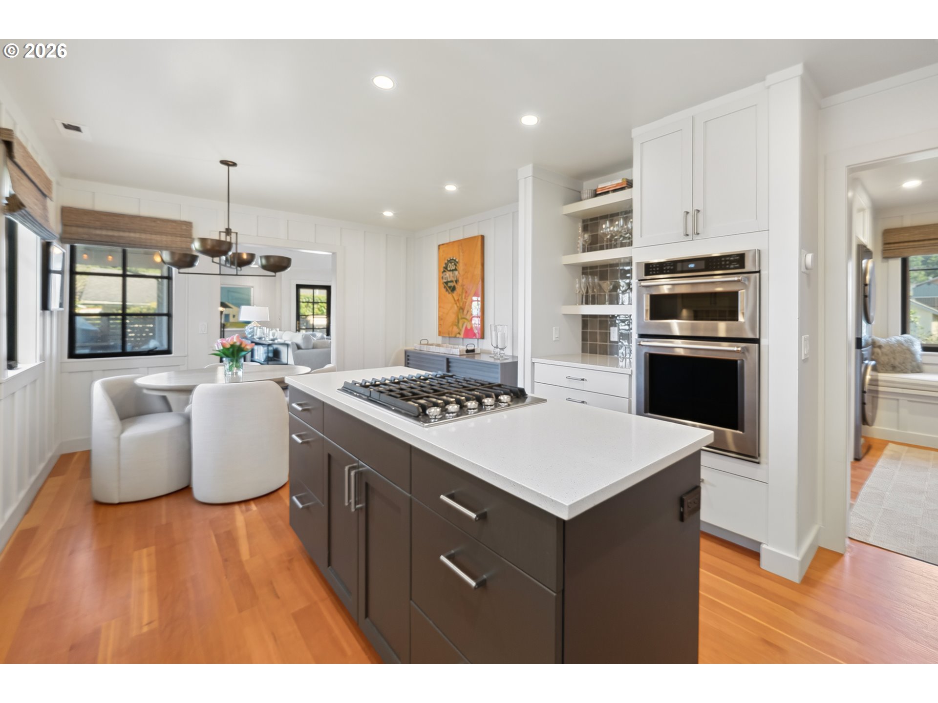 108 West Madison Street Cannon Beach, OR 97110 - Photo 26 of 45 a kitchen that has a table chairs stainless steel appliances and wooden floor