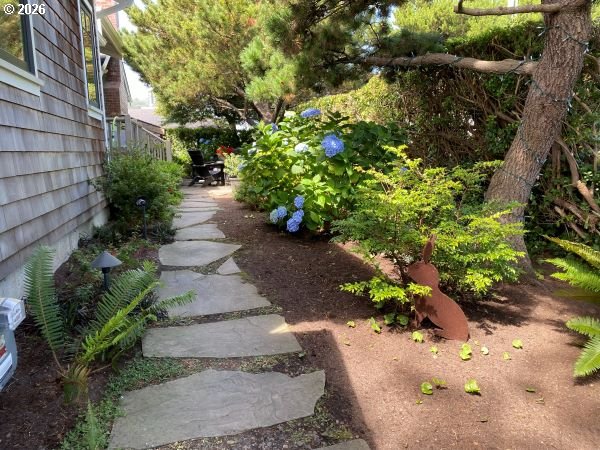 108 West Madison Street Cannon Beach, OR 97110 - Photo 4 of 45 a view of a pathway with a flower plants