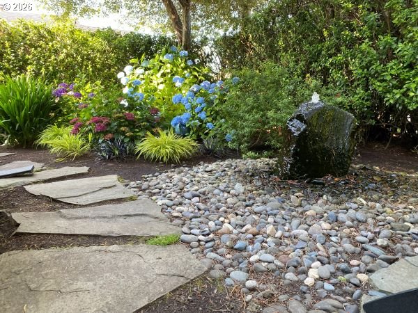 108 West Madison Street Cannon Beach, OR 97110 - Photo 7 of 45 a view of a garden with a bench