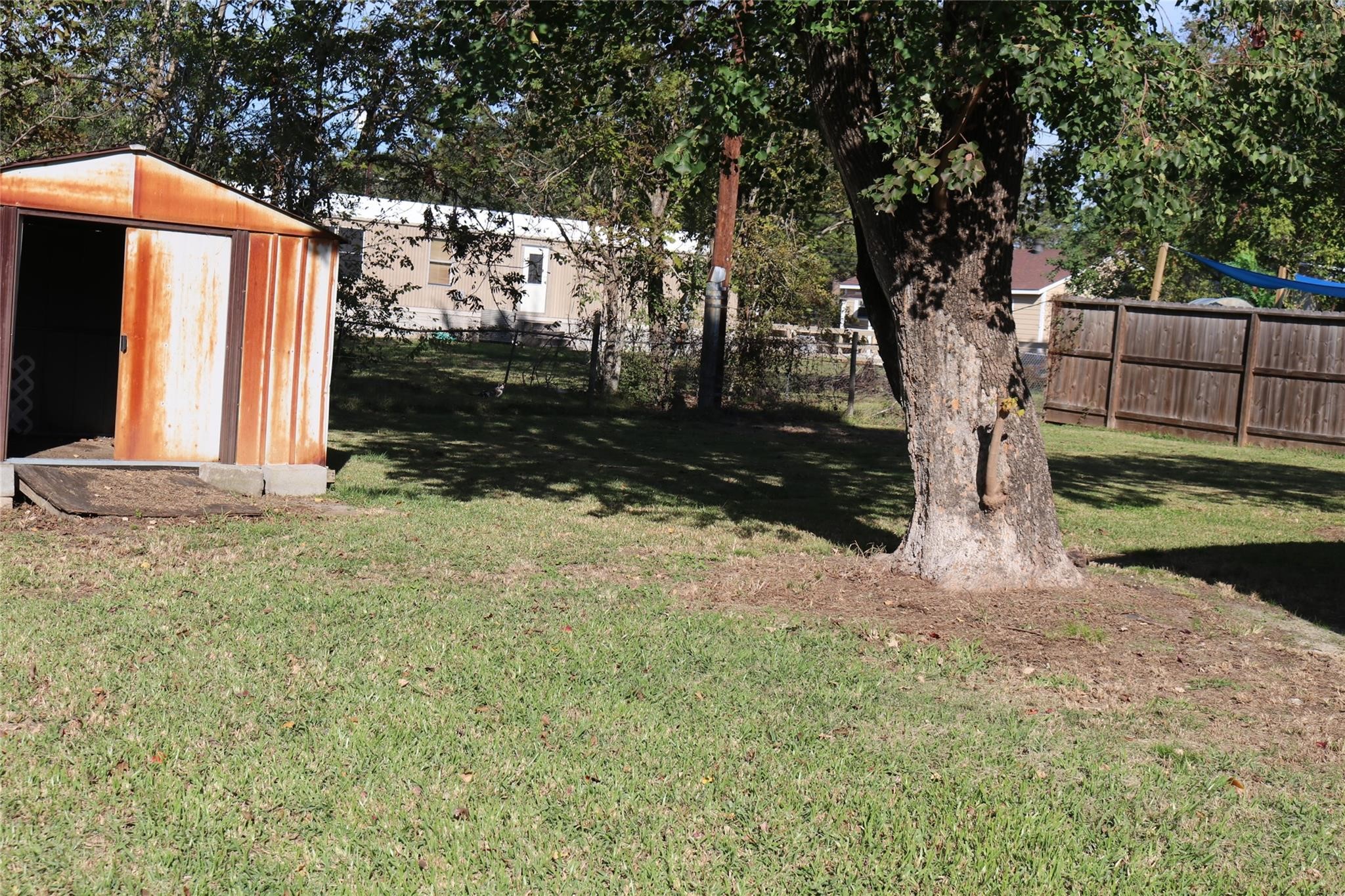 611 Nelson Street Crosby, TX 77532 - Photo 2 of 6 a backyard of a house with lots of green space