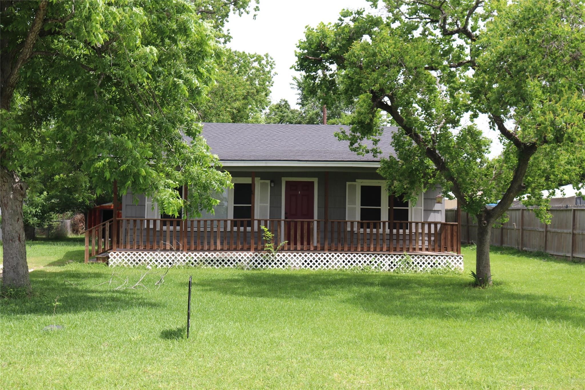 611 Nelson Street Crosby, TX 77532 - Photo 6 of 6 a front view of a house with a garden