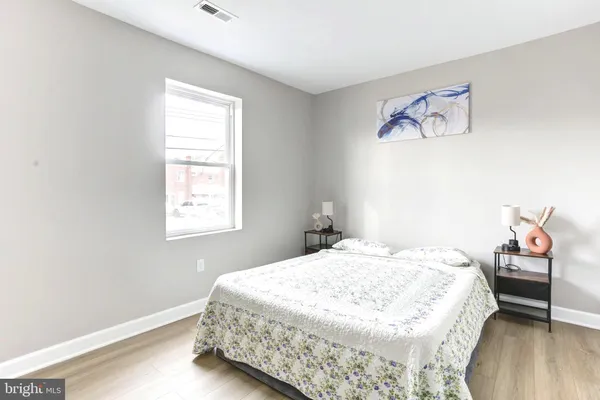 a bedroom with a bed and a window