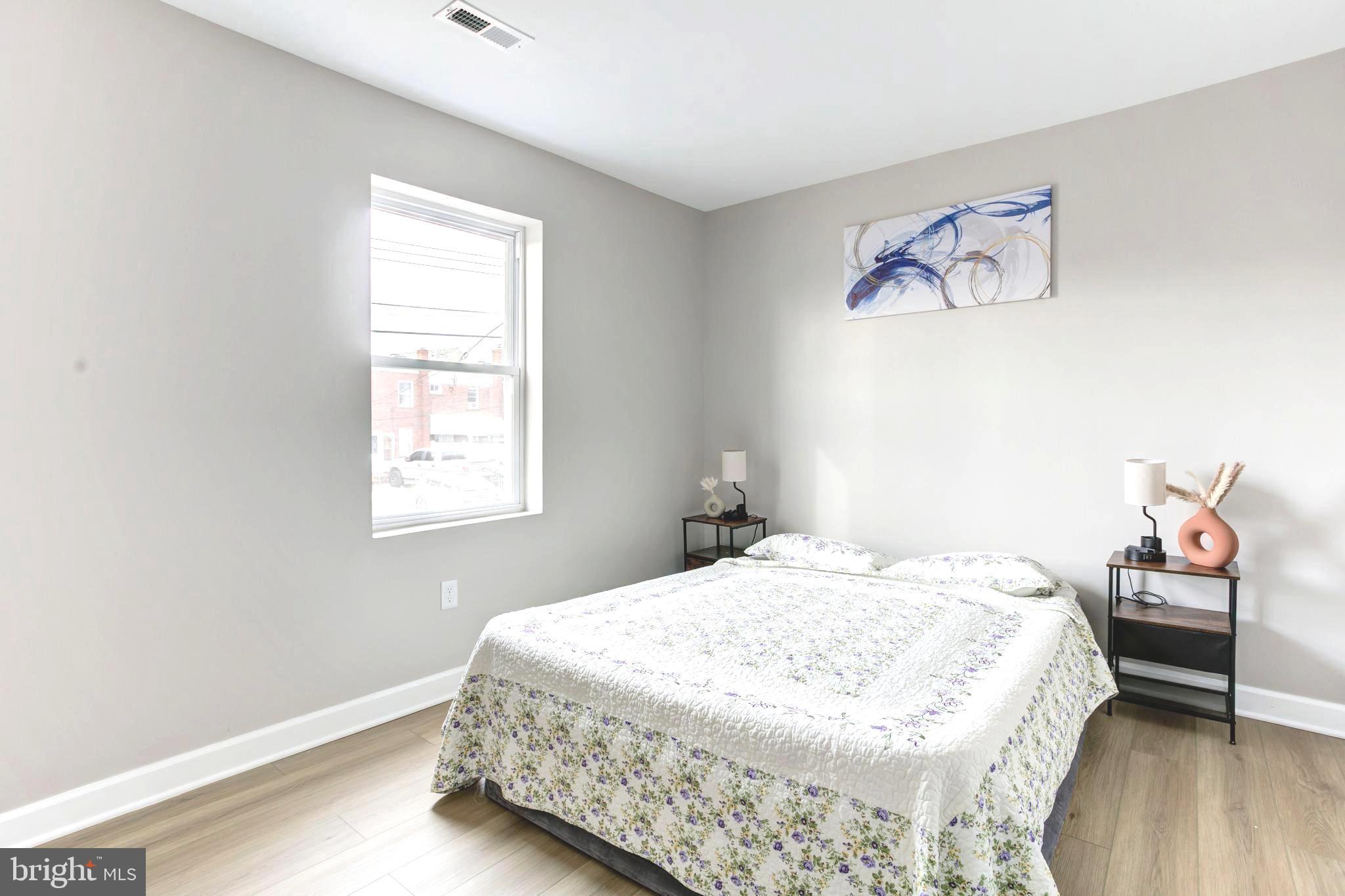 1012 Elton Avenue Baltimore, MD 21224 - Photo 12 of 30 a bedroom with a bed and a window