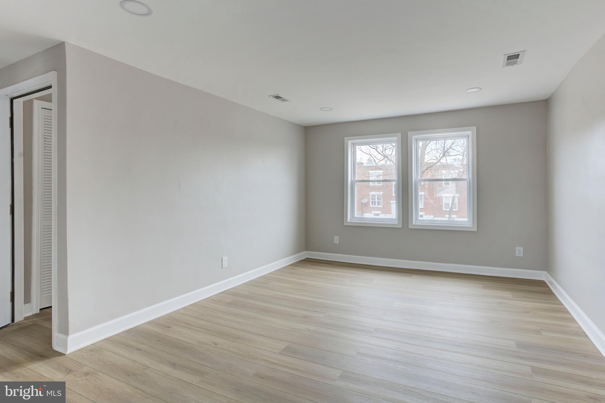 1012 Elton Avenue Baltimore, MD 21224 - Photo 19 of 30 a view of an empty room with wooden floor and a window