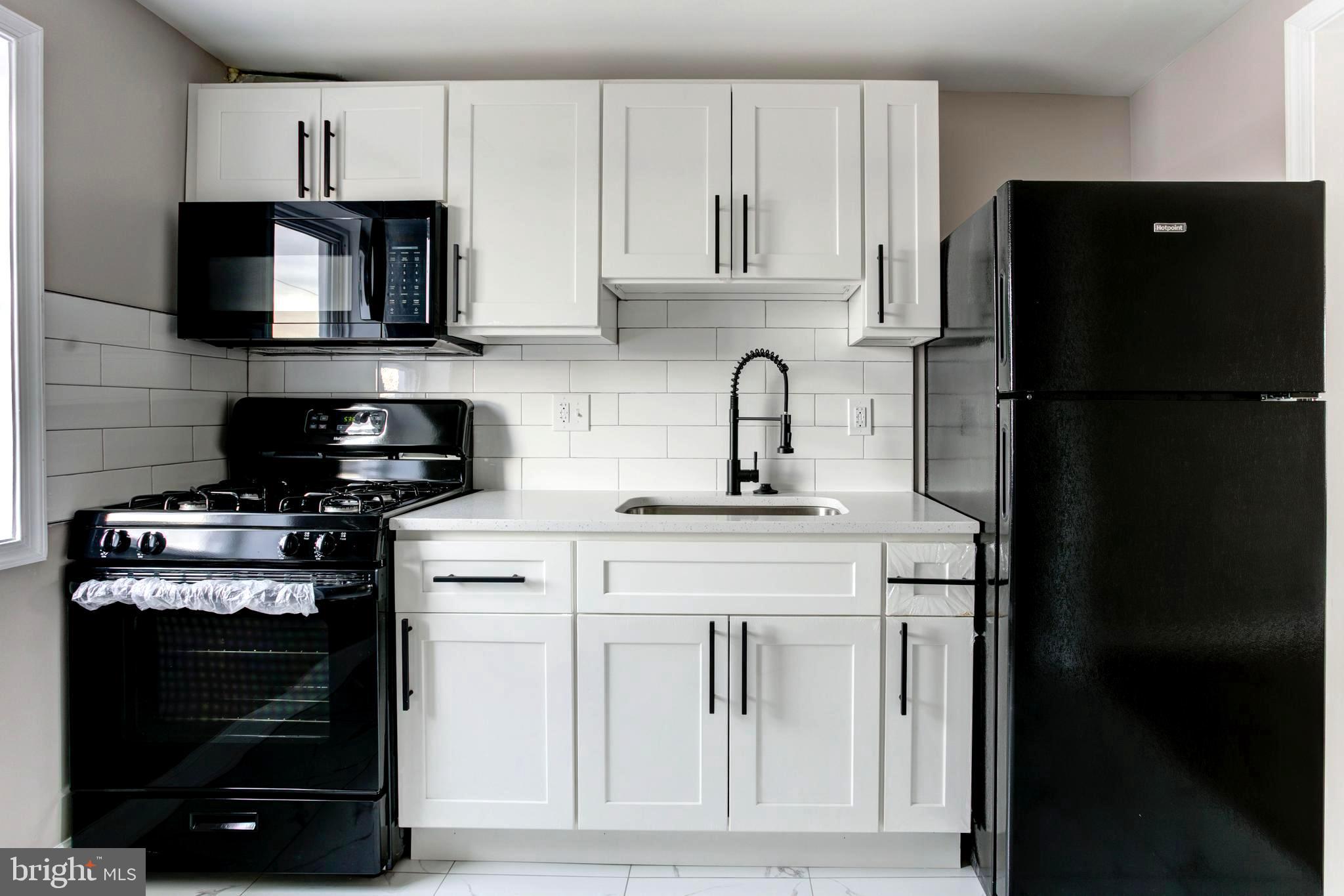 1012 Elton Avenue Baltimore, MD 21224 - Photo 22 of 30 a kitchen with a stove and a refrigerator