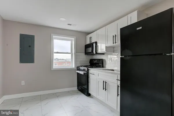 a kitchen with a refrigerator stove and microwave