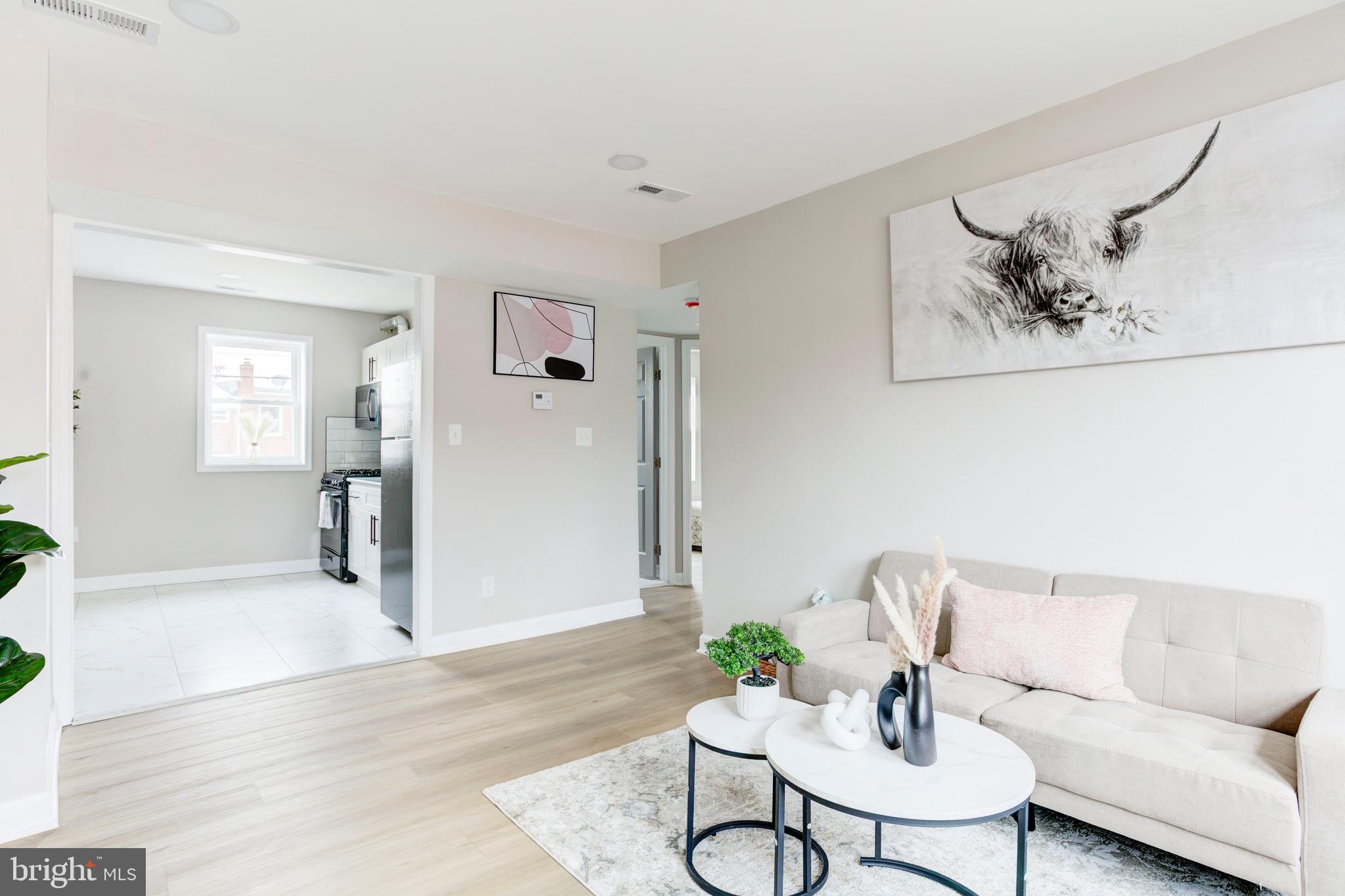 1012 Elton Avenue Baltimore, MD 21224 - Photo 3 of 30 a living room with furniture and wooden floor