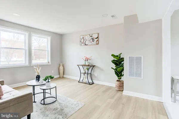 a living room with furniture and a potted plant