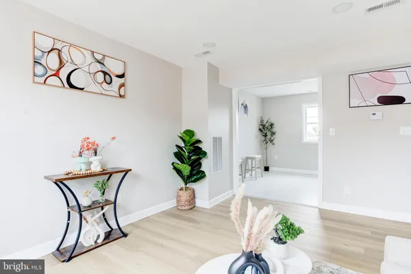 a dining room with furniture and wooden floor
