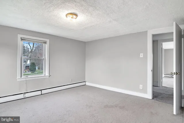 an empty room with windows and closet