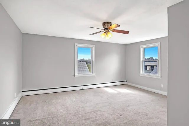 a view of an empty room and a window