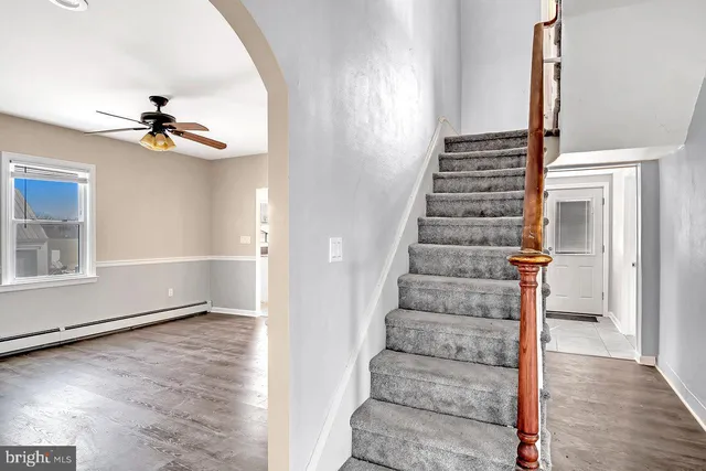 a view of entryway and hall with wooden floor