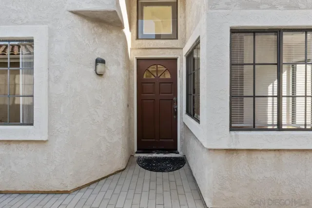 a living room with a fireplace and wooden floor
