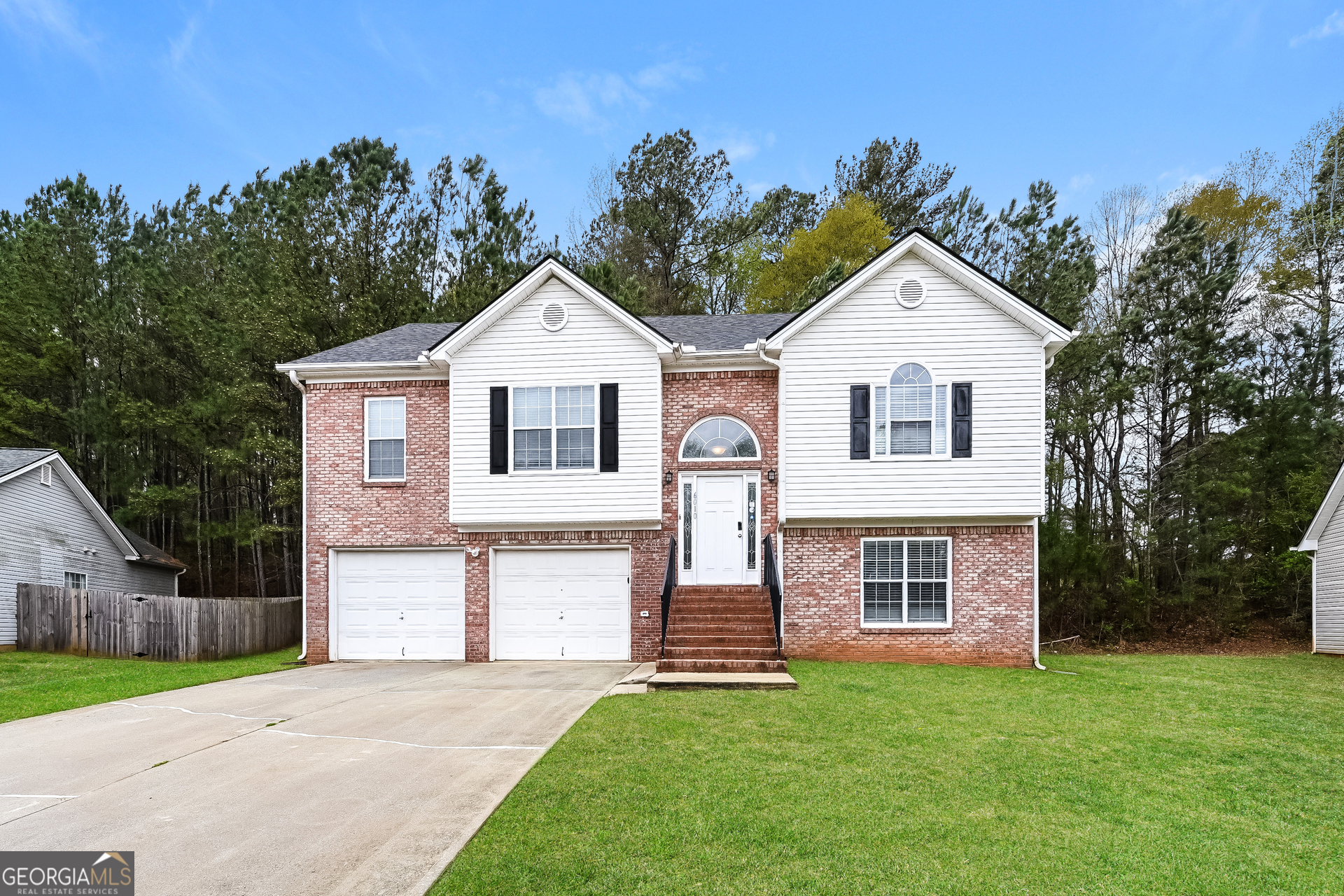 6010 Arbor Links Road Lithonia, GA 30058 - Photo 1 of 1 a front view of a house with a garden