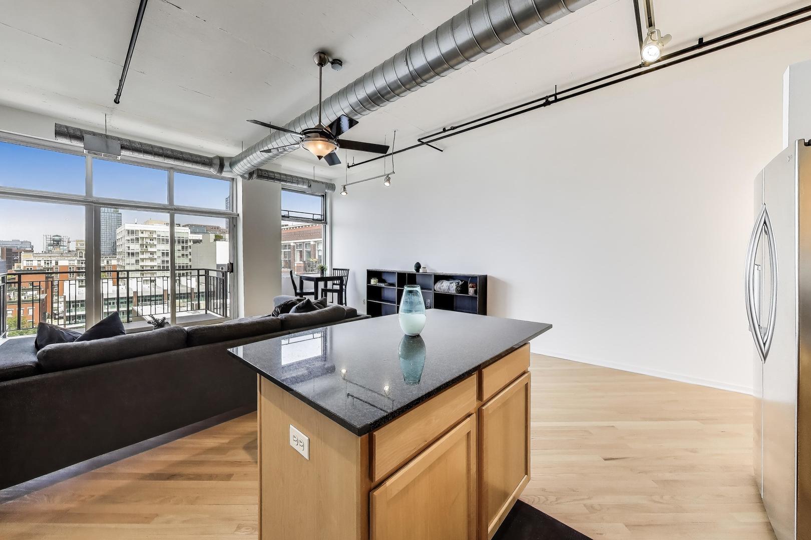 1000 West Adams Street, Unit 815 Chicago, IL 60607 - Photo 13 of 40 a view of a kitchen with a sink a counter top space and stainless steel appliances