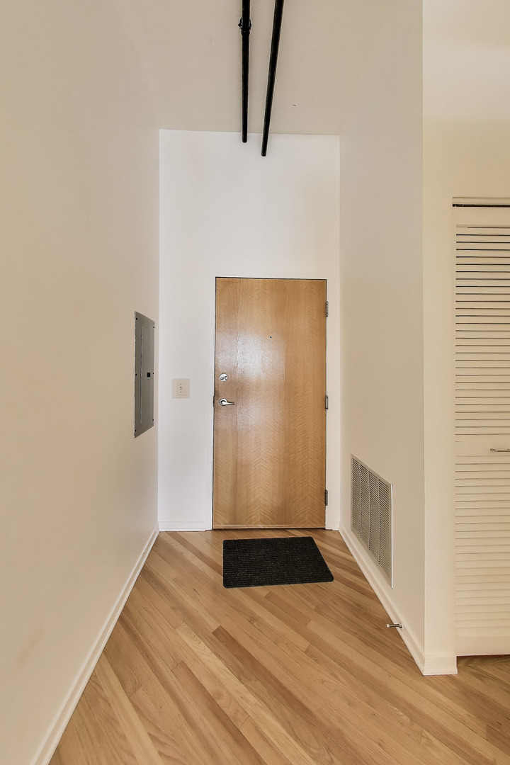 1000 West Adams Street, Unit 815 Chicago, IL 60607 - Photo 2 of 40 a view of an empty room with wooden floor