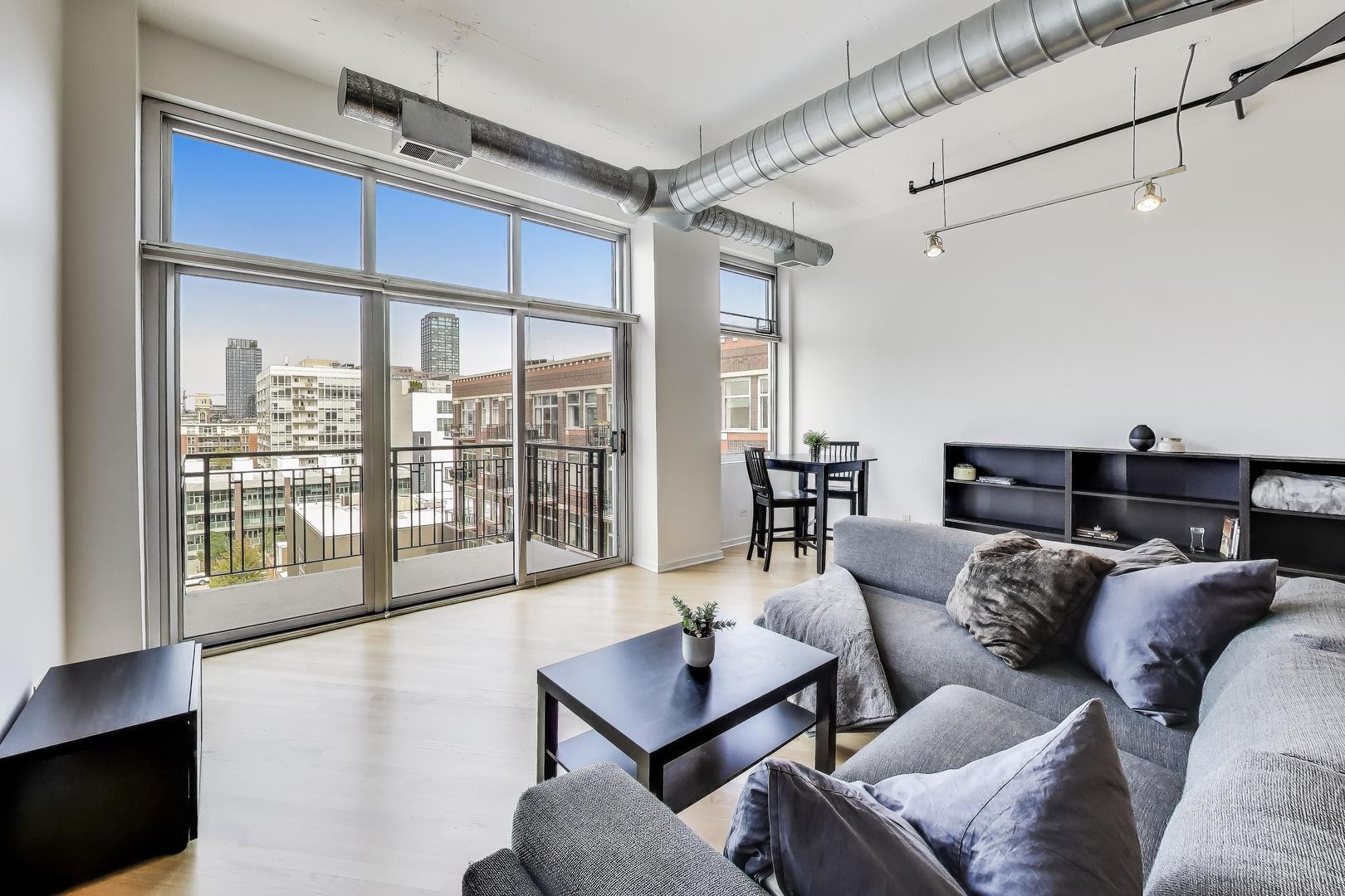 1000 West Adams Street, Unit 815 Chicago, IL 60607 - Photo 7 of 40 a living room with furniture and a floor to ceiling window