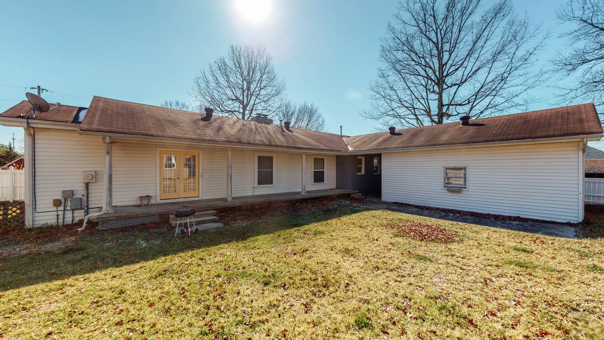 241 Hunt Creek Road Manchester, TN 37355 - Photo 32 of 33 a backyard of a house with large trees and barbeque oven