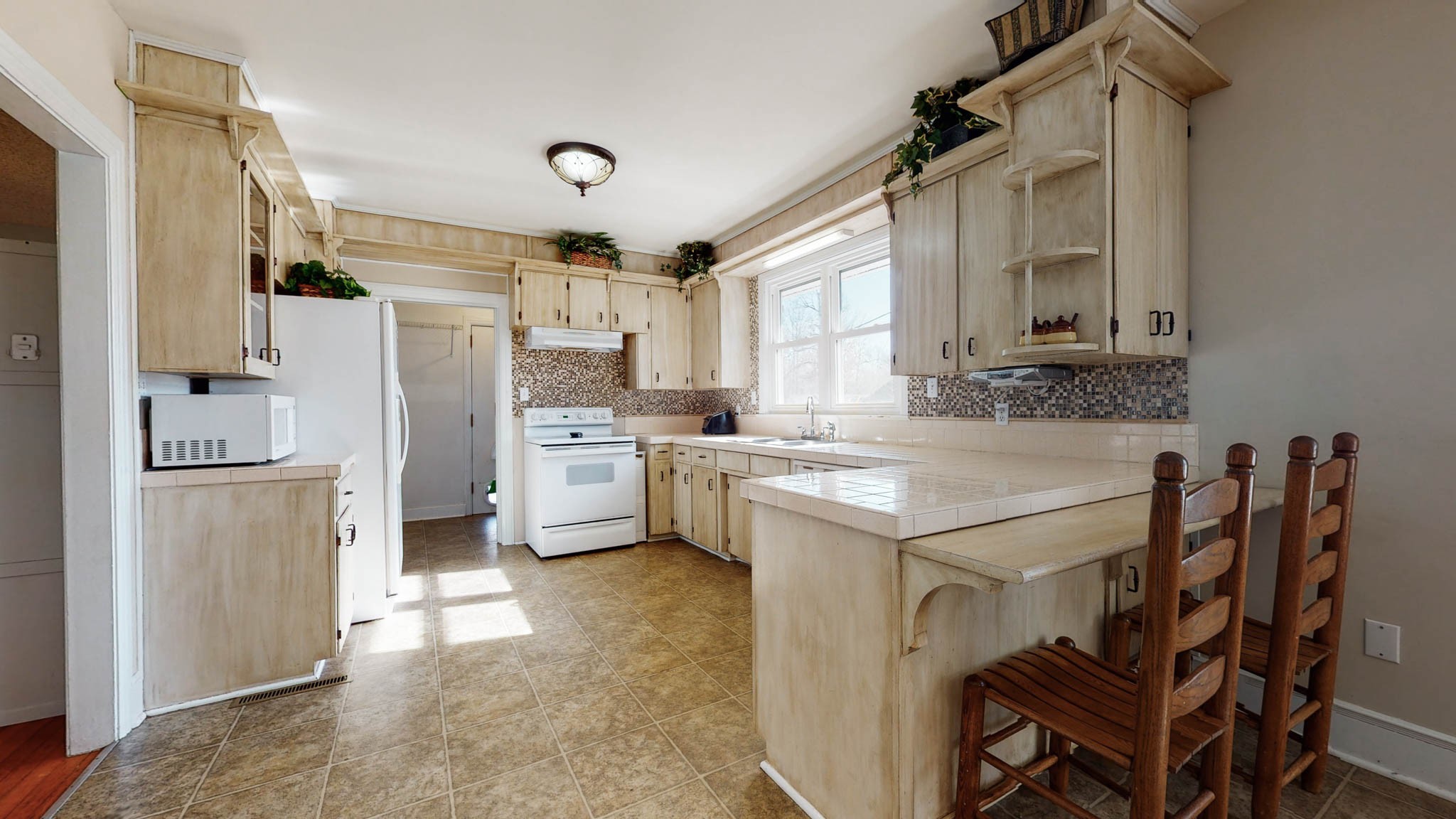 241 Hunt Creek Road Manchester, TN 37355 - Photo 6 of 33 a kitchen with white cabinets and stainless steel appliances
